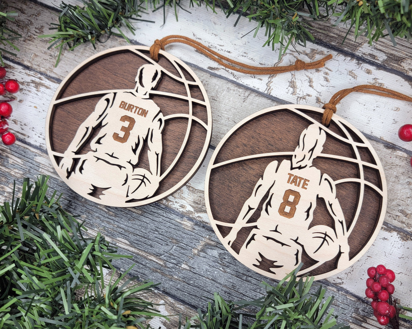 two basketball ornament hanging from a christmas tree
