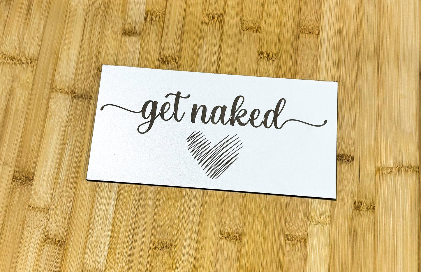 a piece of paper with the words get naked on it