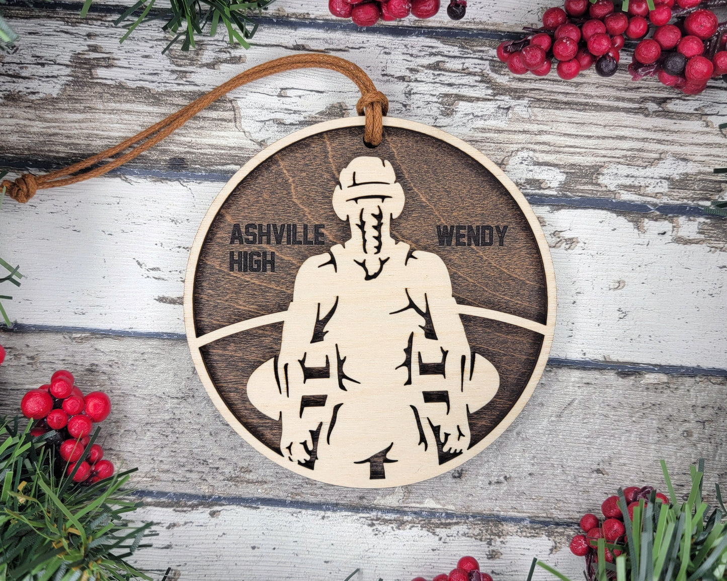 a wooden ornament with a picture of a man holding a surfboard