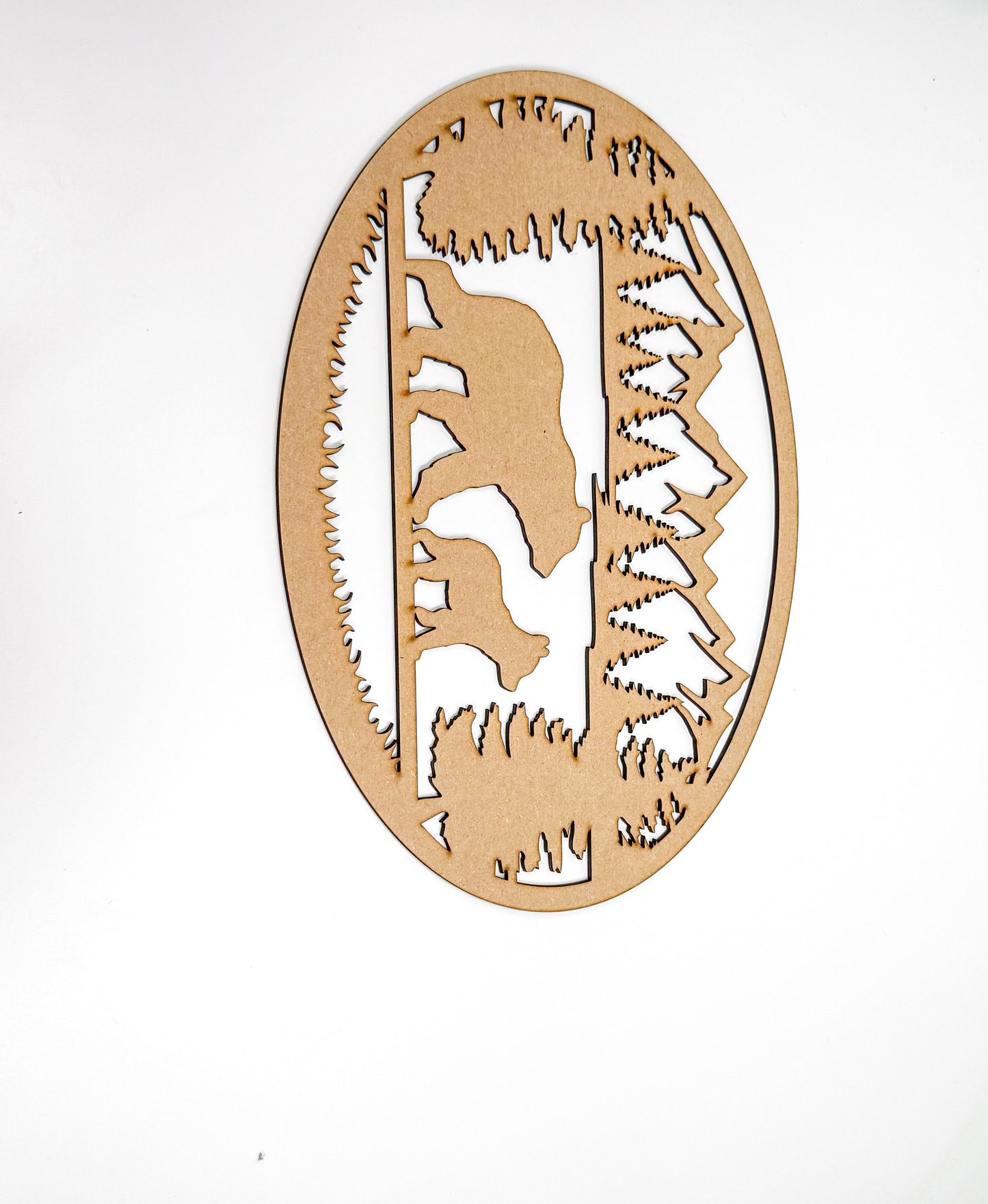 a wooden cutout of a bear in a forest