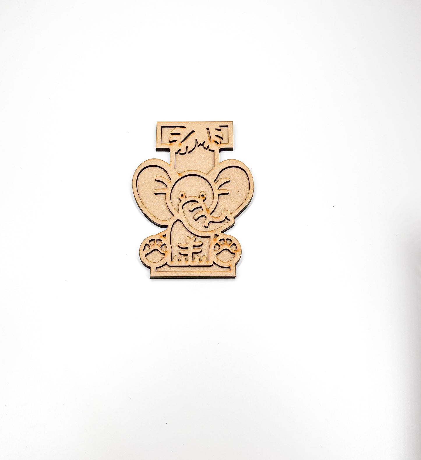 a wooden cutout of an elephant on a white background