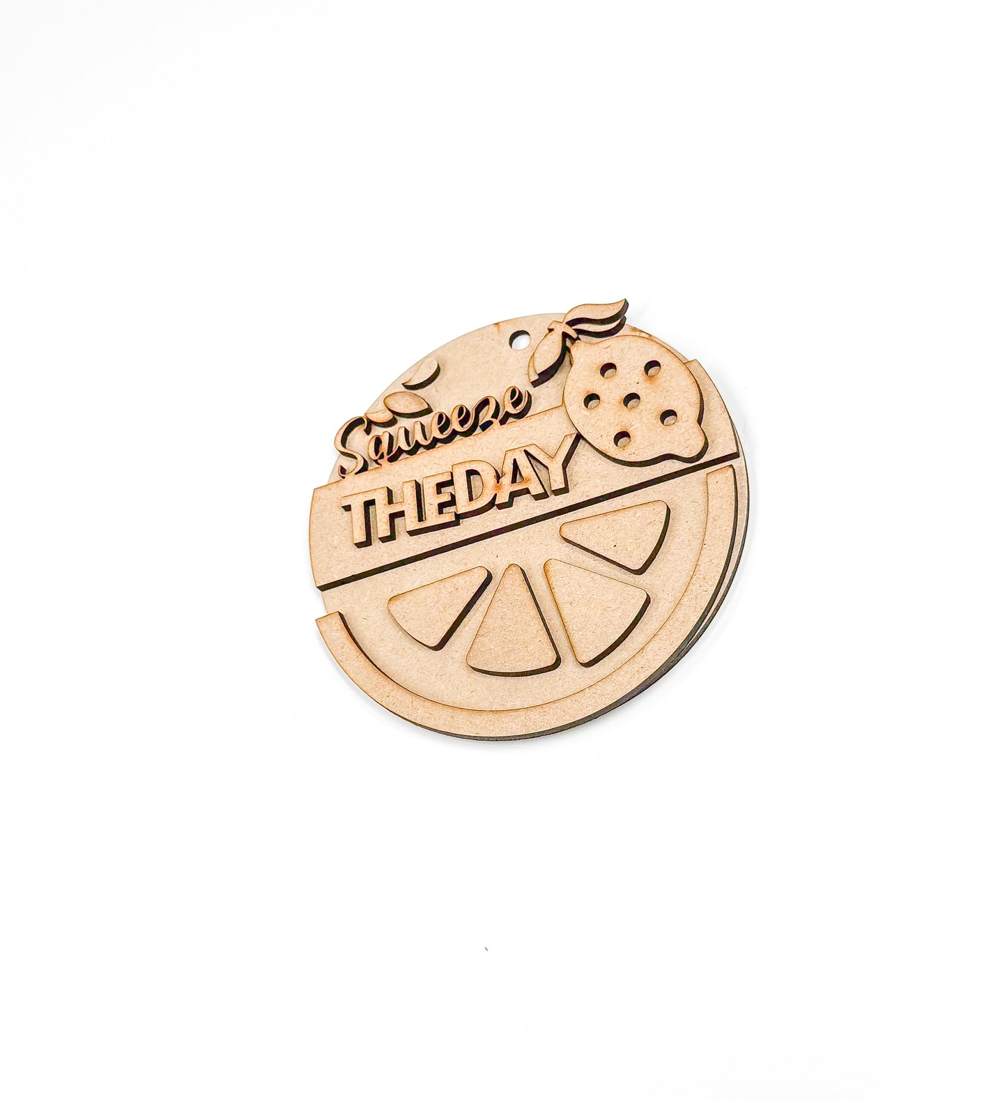 a wooden ornament with a slice of fruit on it