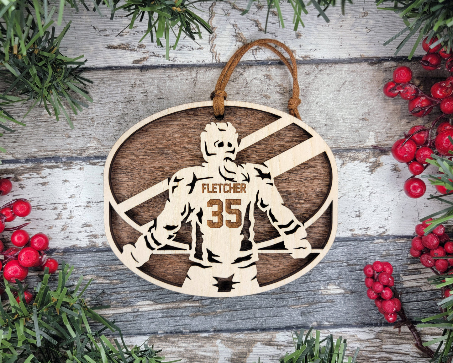 a wooden ornament with a picture of a football player
