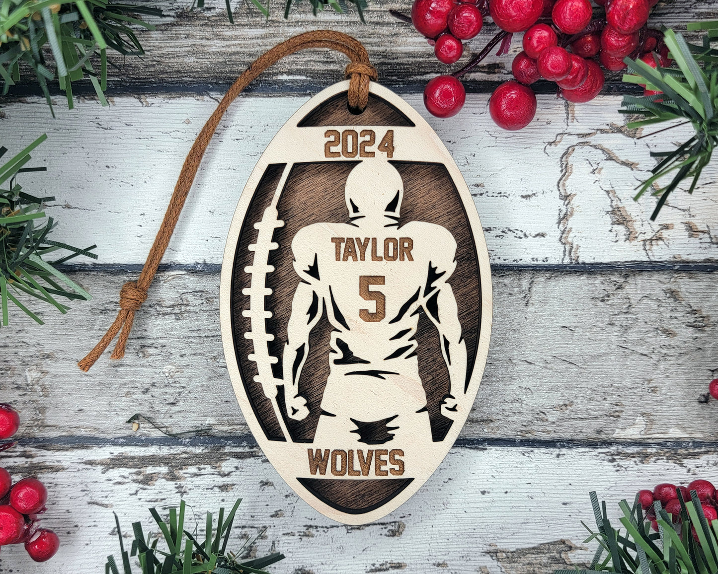a wooden ornament with a football player on it