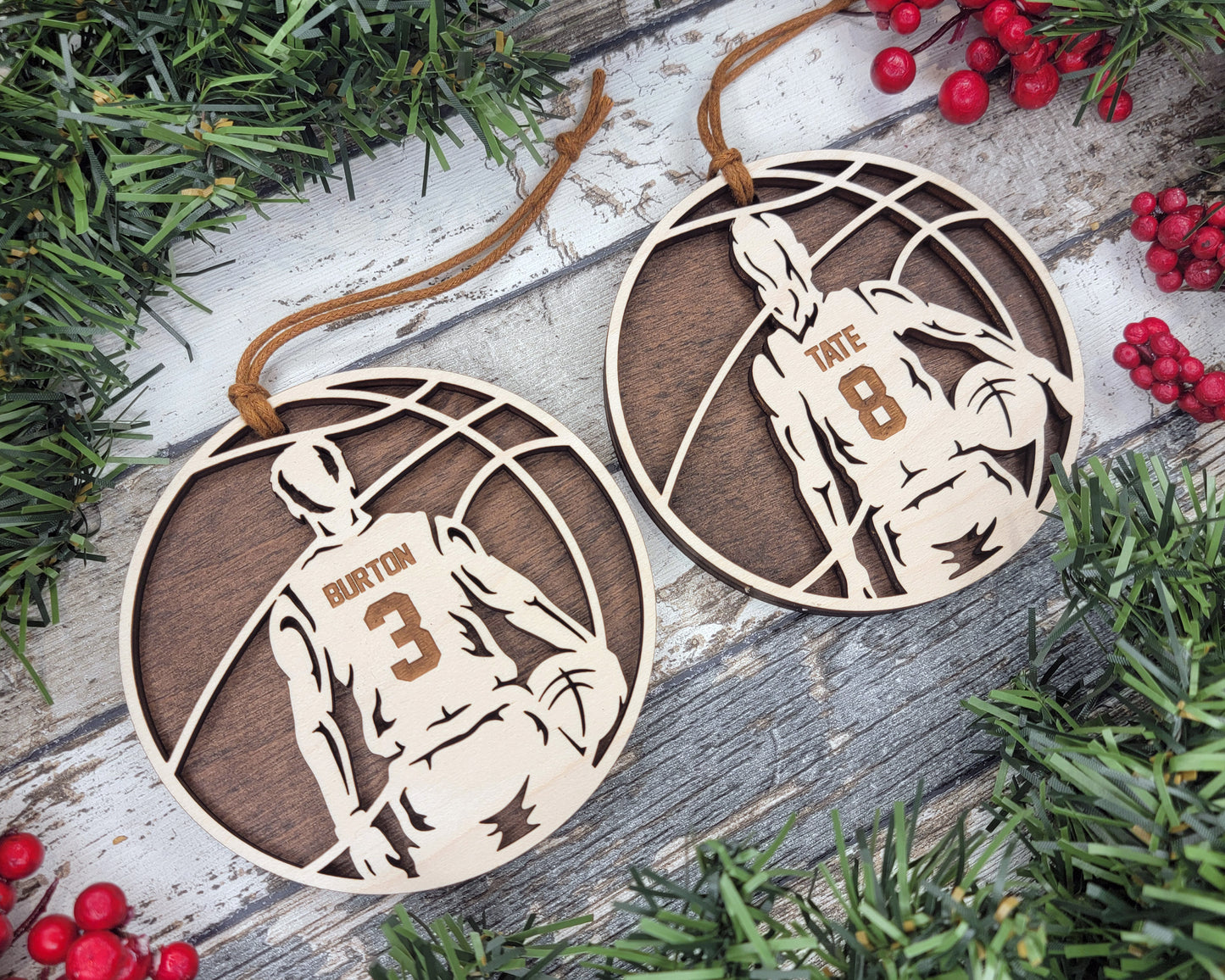 a pair of wooden basketball ornament hanging from a christmas tree
