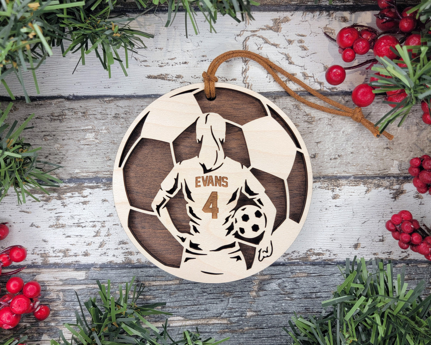 a wooden ornament with a picture of a man holding a soccer ball