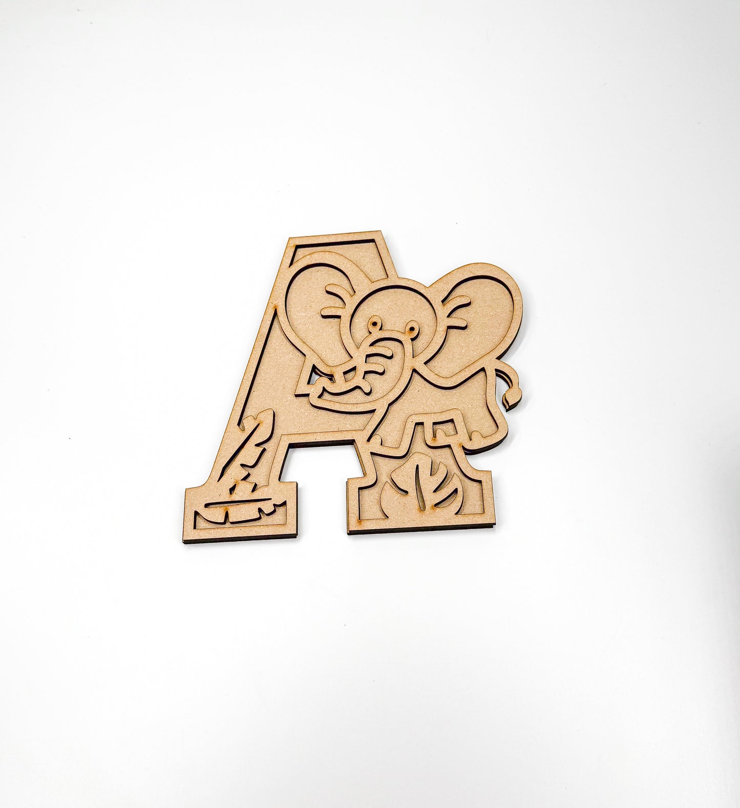 a wooden cutout of an elephant with the letter a