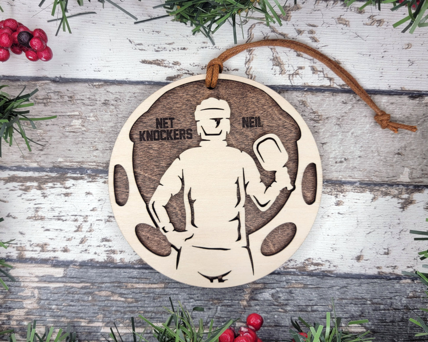 a wooden ornament with a picture of a man holding a boxing glove