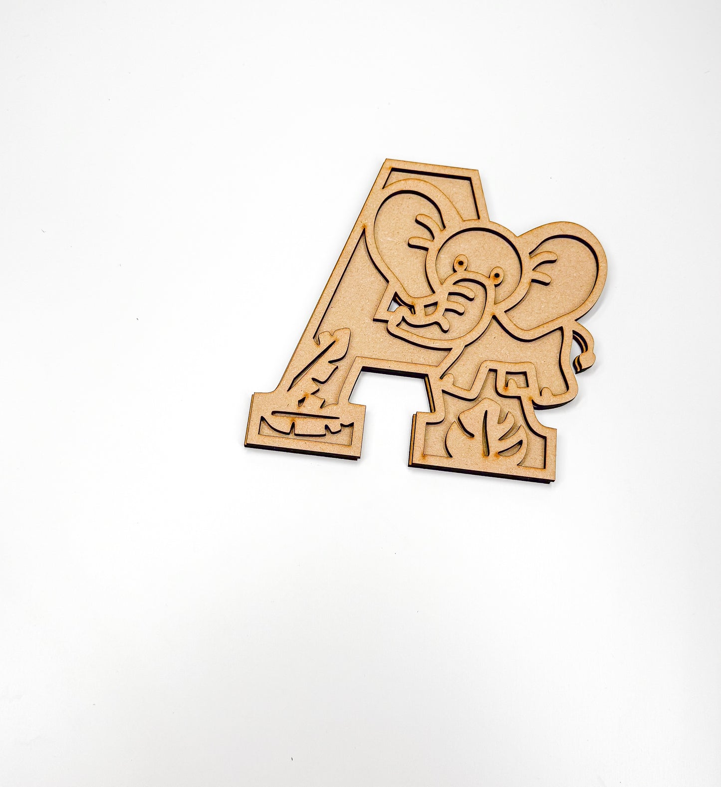 a wooden cutout of an elephant on a white background