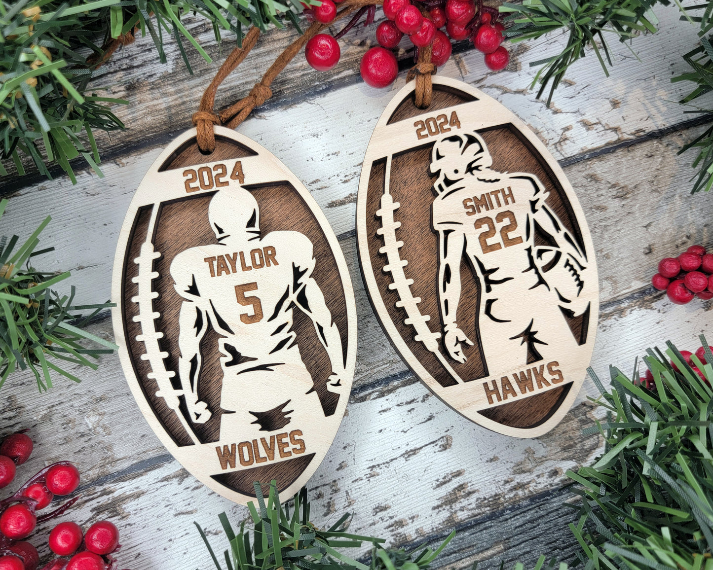 a pair of wooden football ornament hanging from a christmas tree