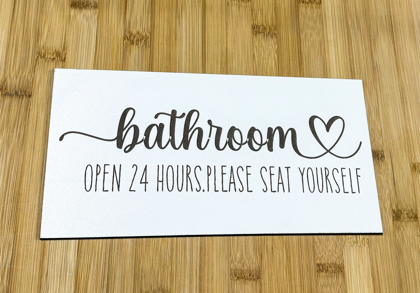 a sign that says bathroom open 24 hours please seat yourself