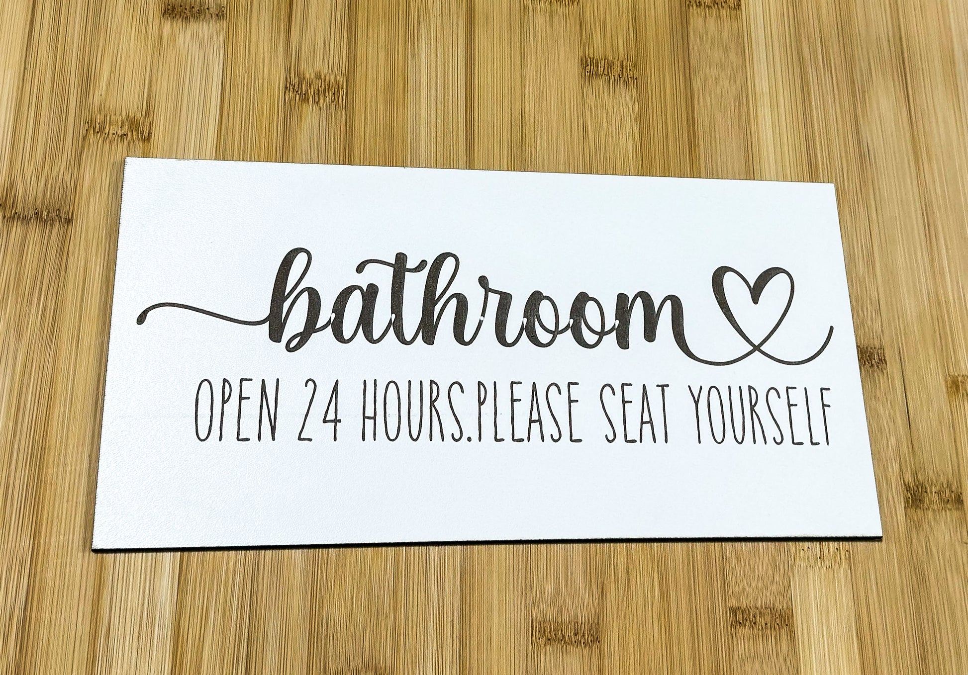 a sign that says bathroom open 24 hours please seat yourself