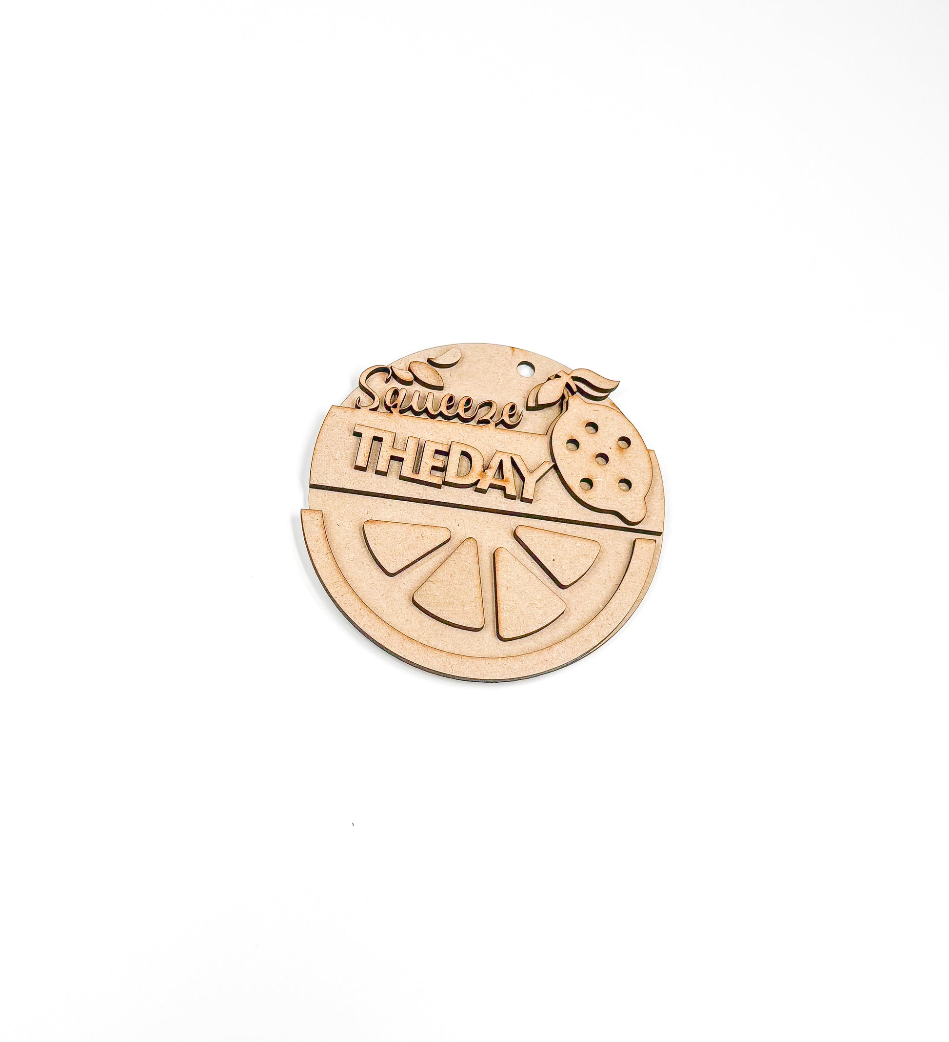 a wooden brooch with a piece of fruit on it