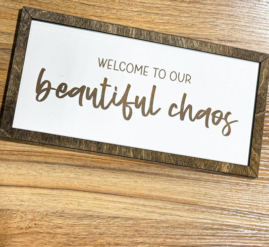 a sign that says, welcome to our beautiful chaos