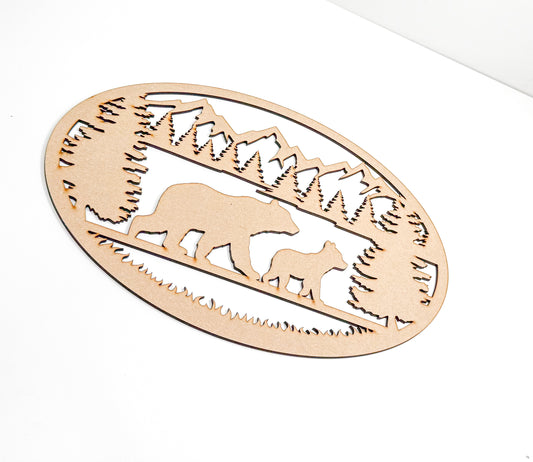 a wooden cutout of a bear and cub in the woods