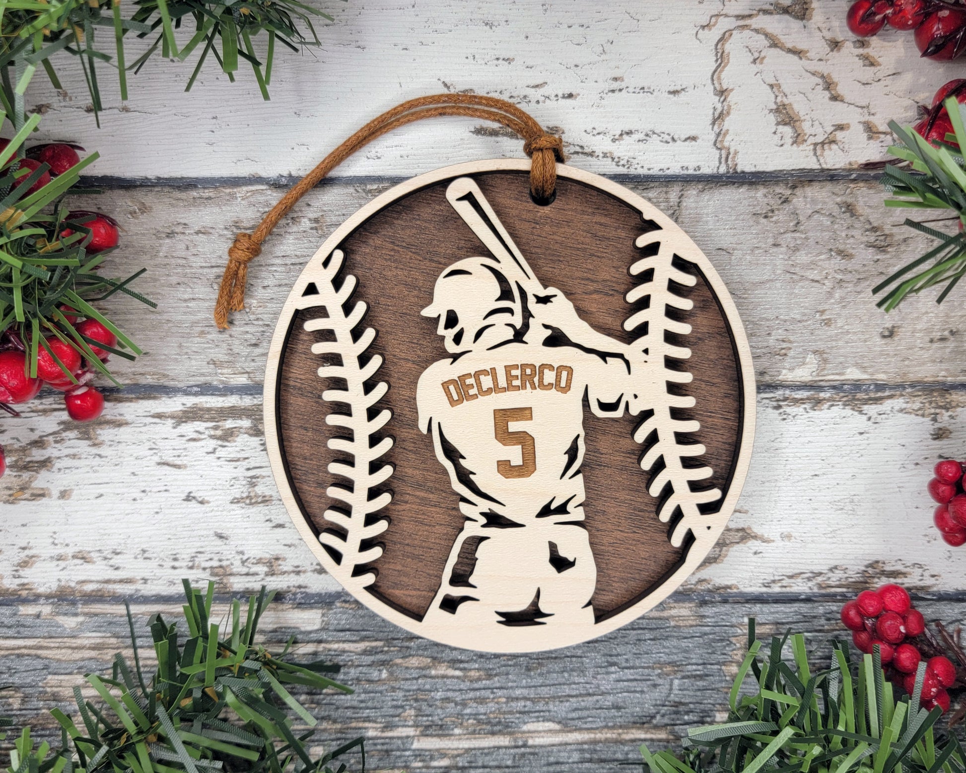 a wooden ornament with a baseball player holding a bat