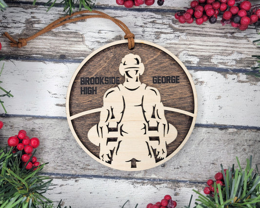 a wooden ornament with a picture of a man holding a surfboard