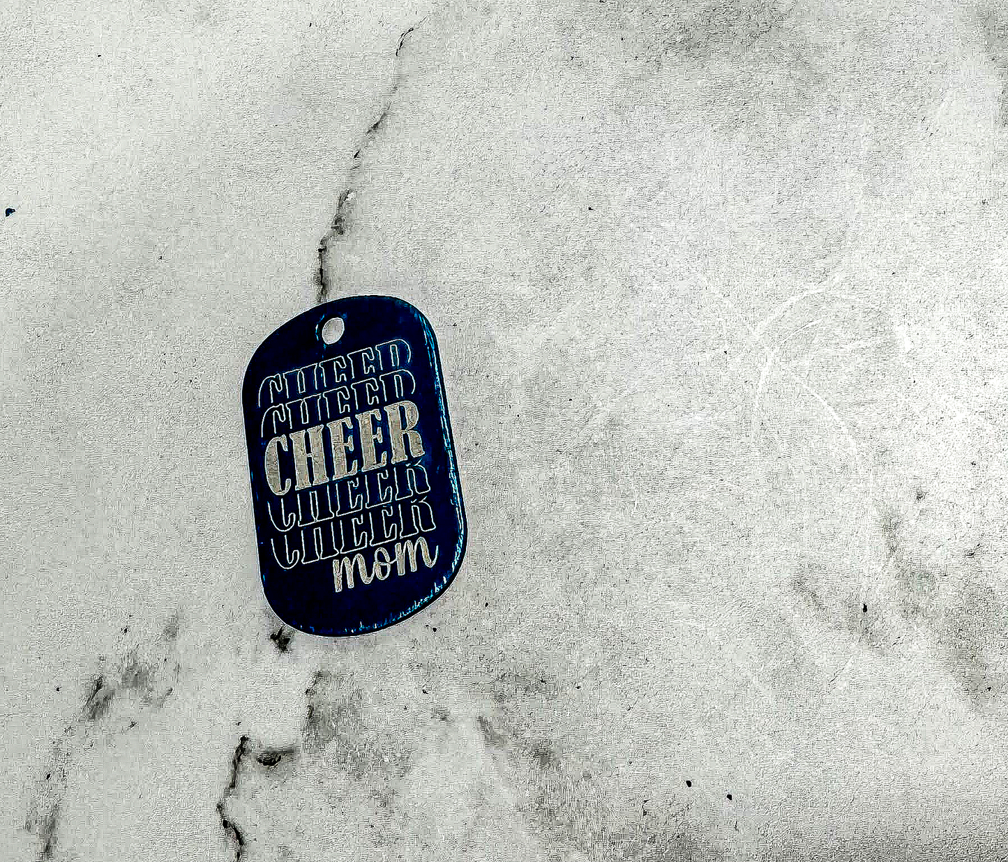 a dog tag that is laying on the ground