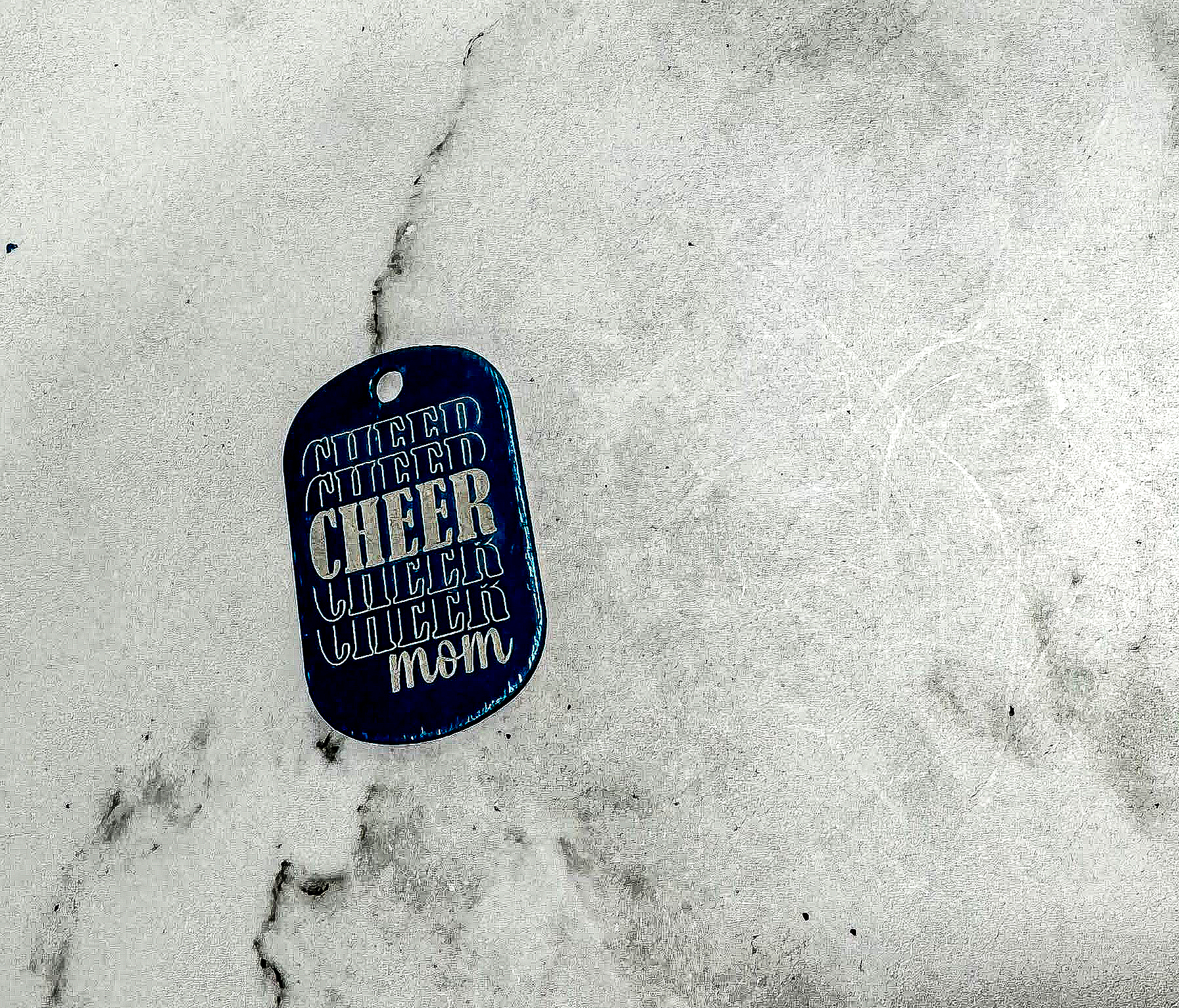 a dog tag that is laying on the ground