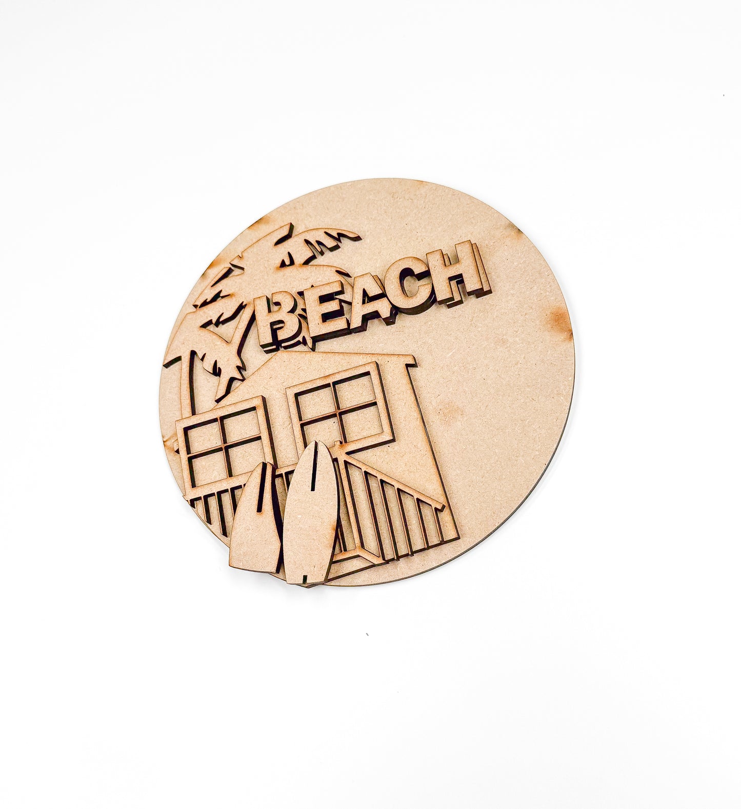 a wooden plaque with a picture of a beach