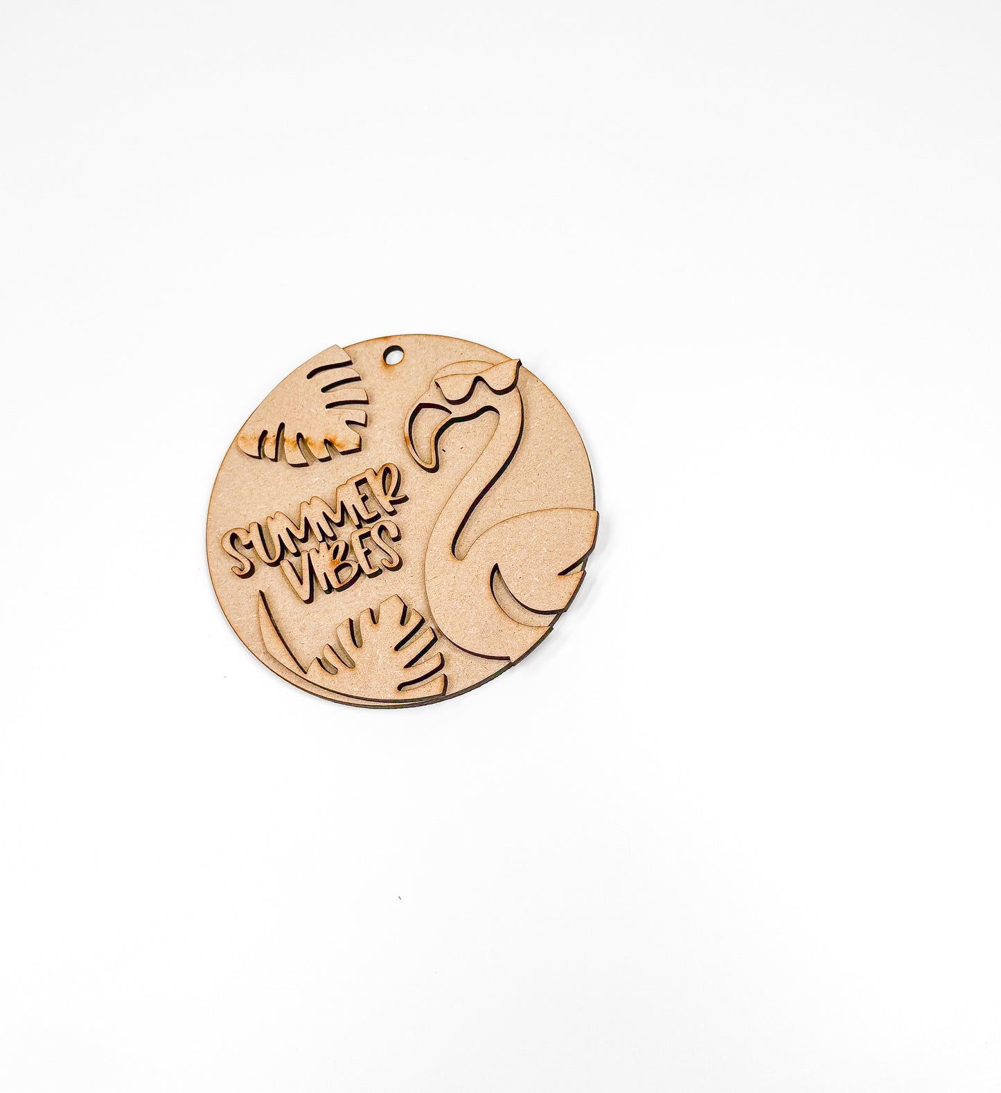 a wooden brooch with a picture of a cat and a fish on it