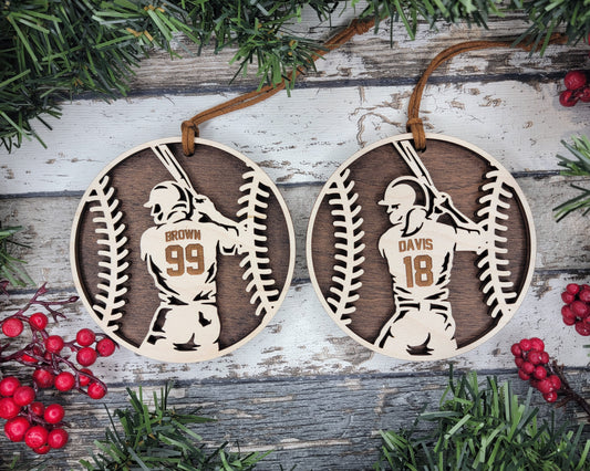 two baseball ornament hanging from a tree
