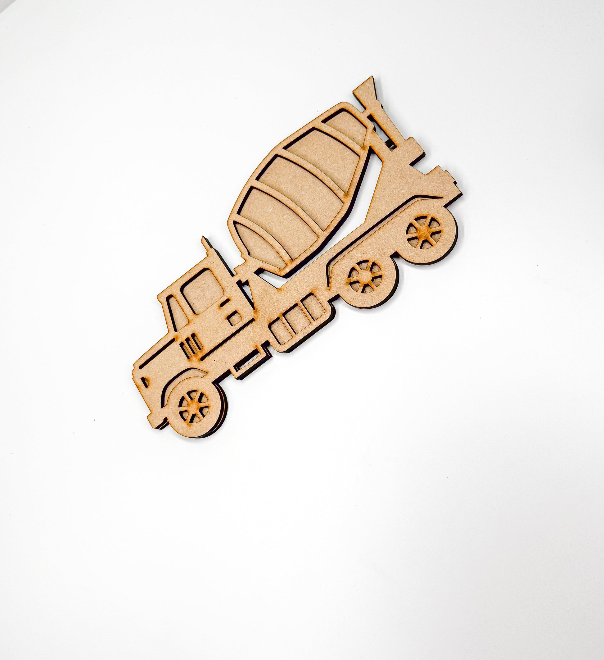 a wooden cutout of a truck on a white background