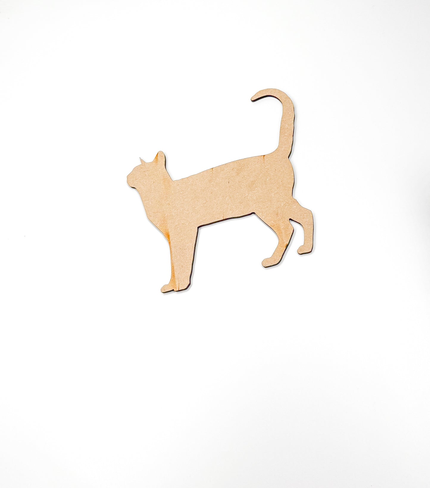 a wooden cutout of a cat on a white background
