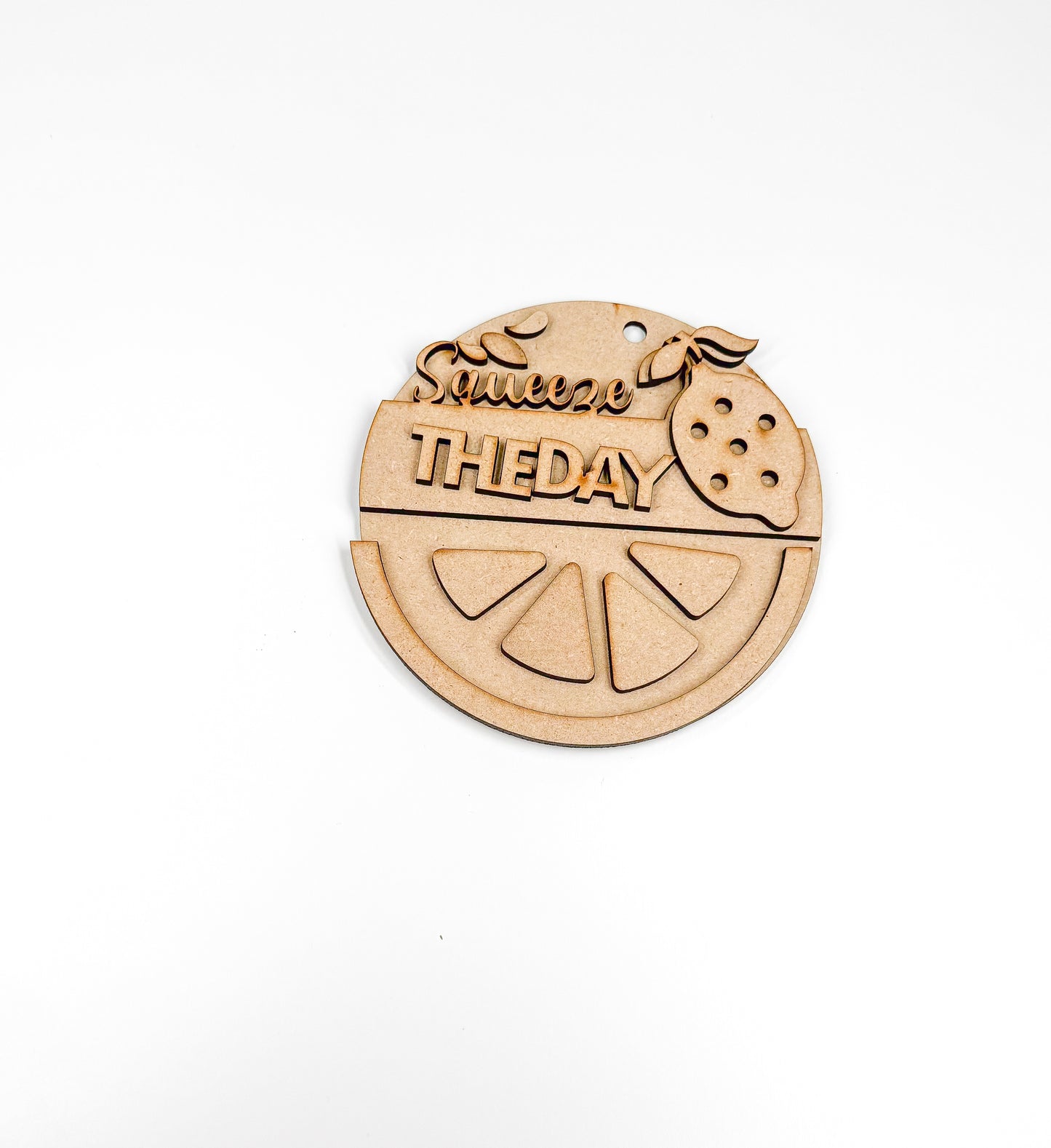 a wooden ornament with a slice of fruit on it