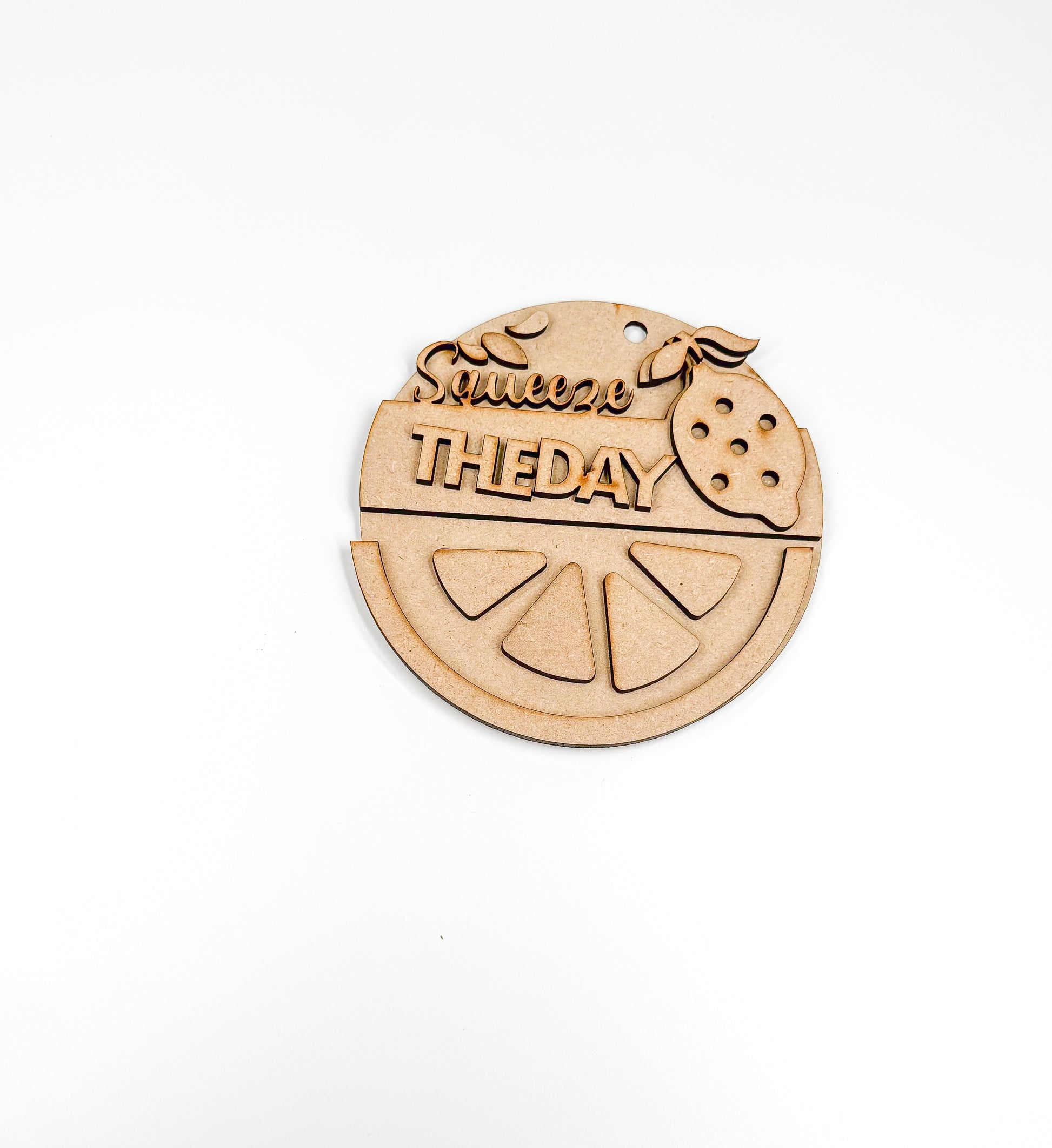 a wooden ornament with a slice of fruit on it