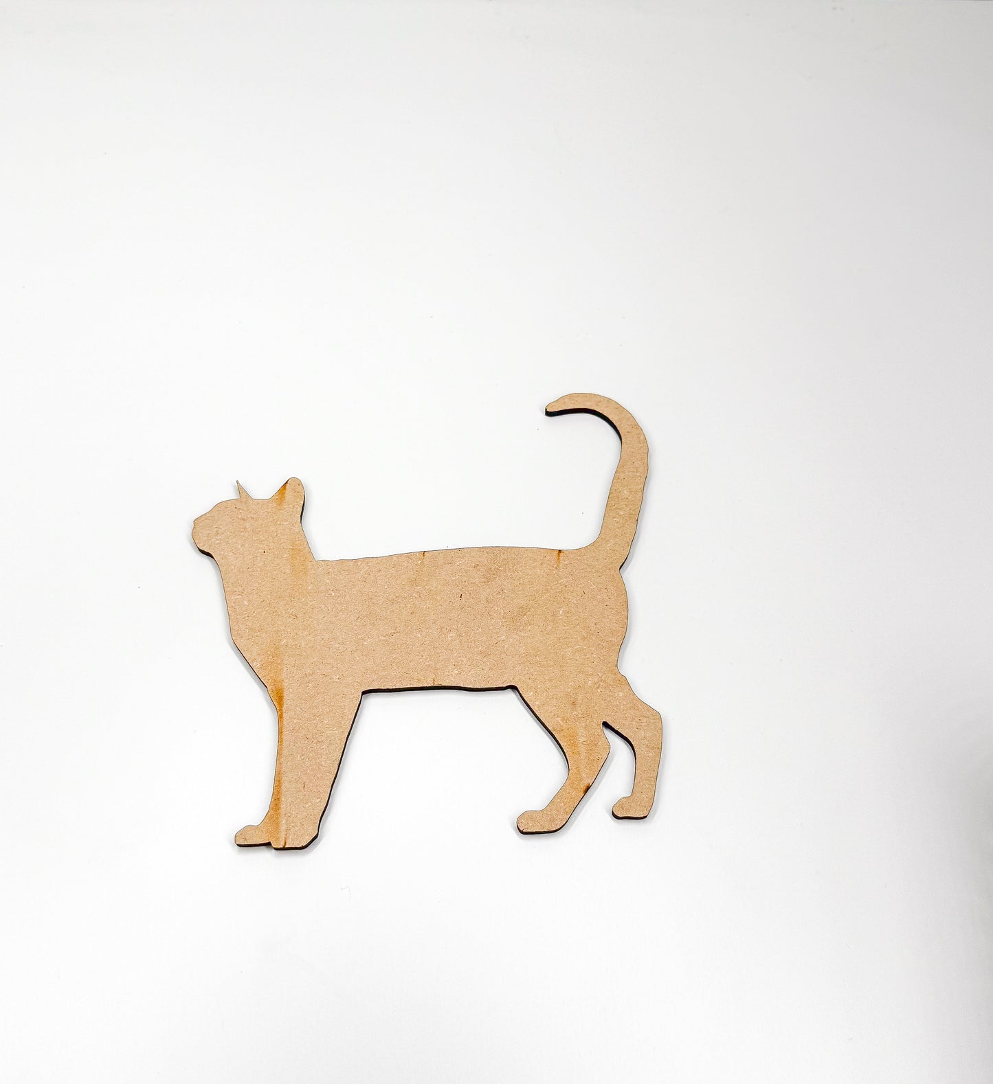 a wooden cutout of a cat on a white background