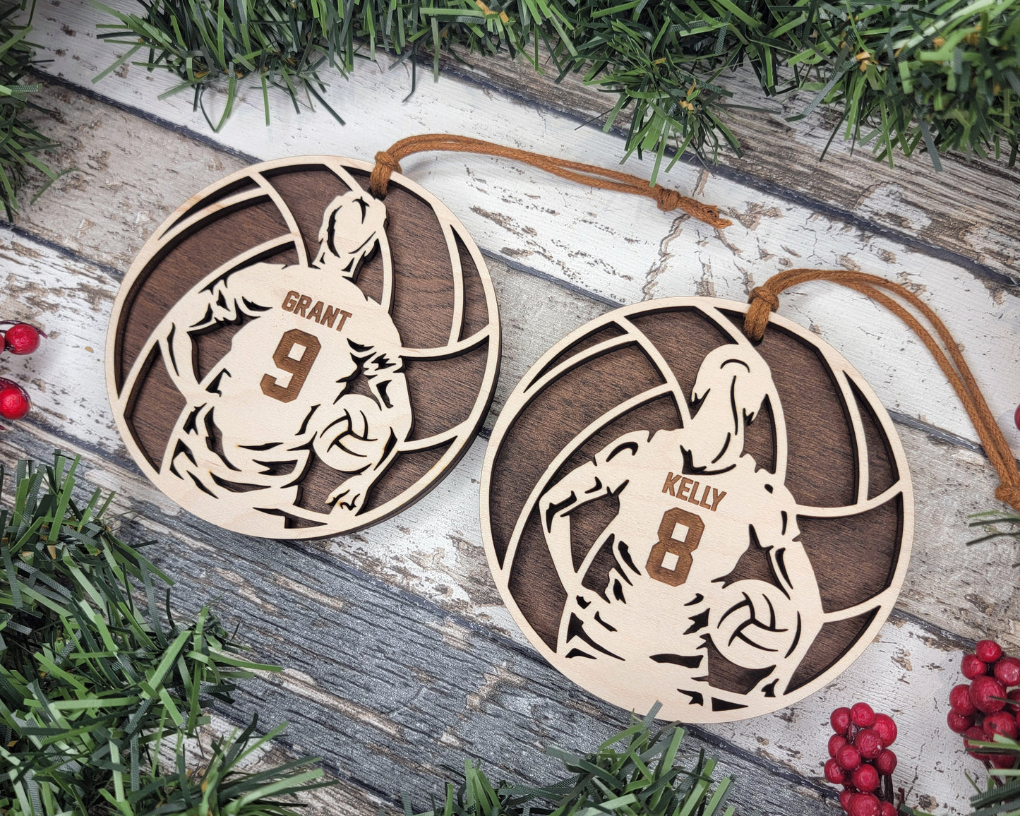 two wooden ornament hanging from a christmas tree