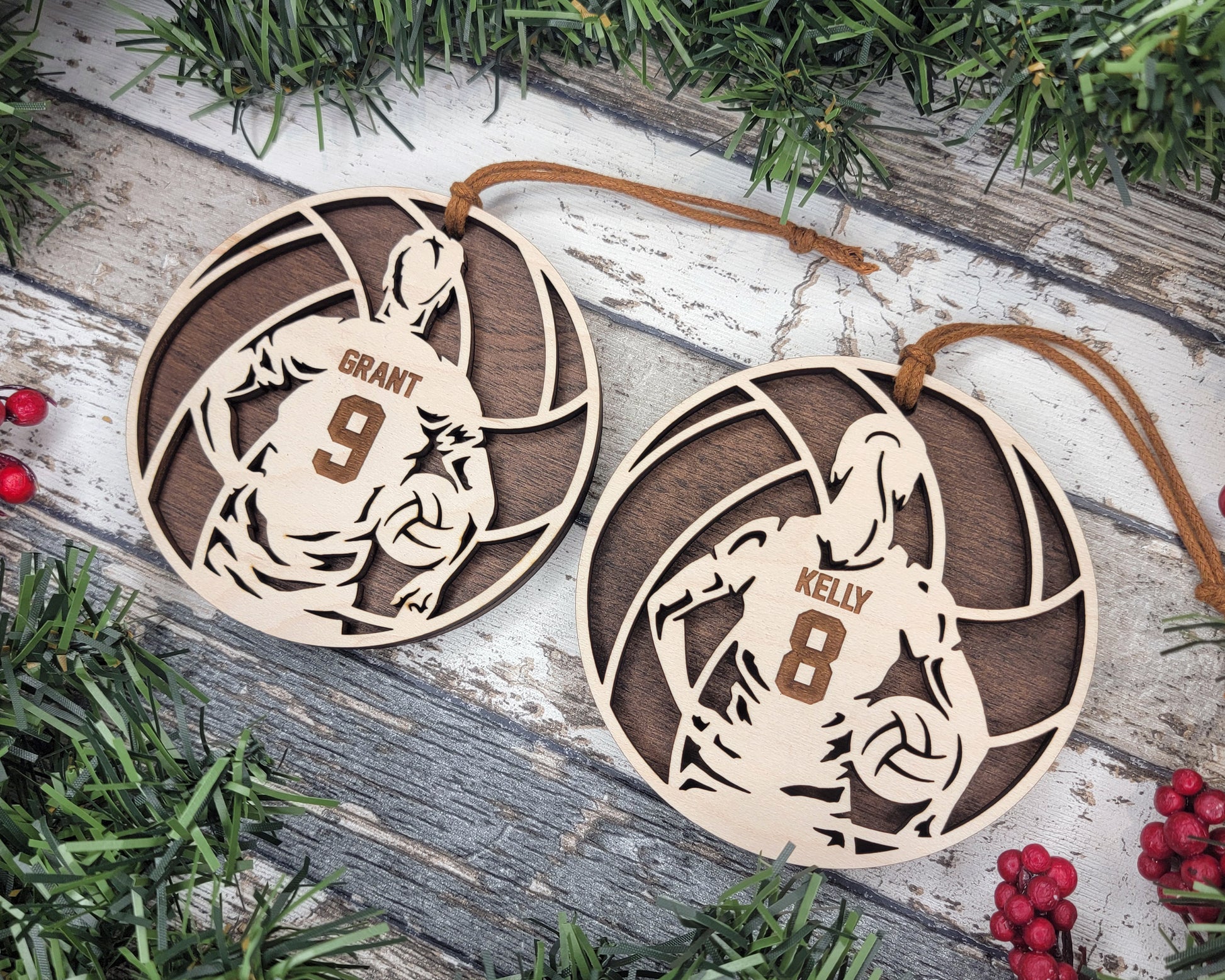 two wooden ornament hanging from a christmas tree