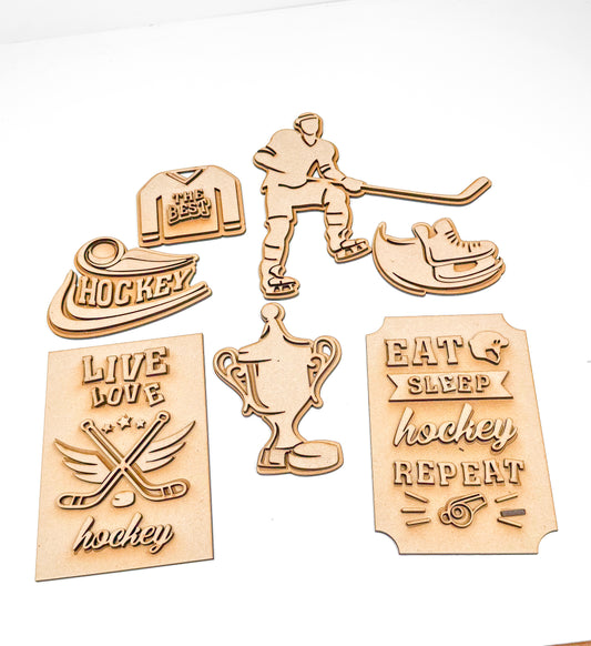 a group of wooden cutouts of various sports related items