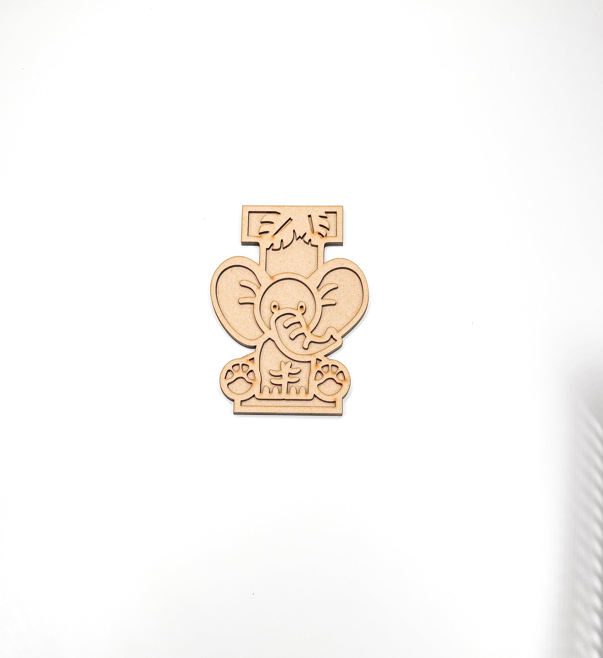 a wooden cutout of an elephant on a white background