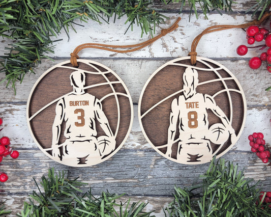 two basketball ornament hanging from a christmas tree