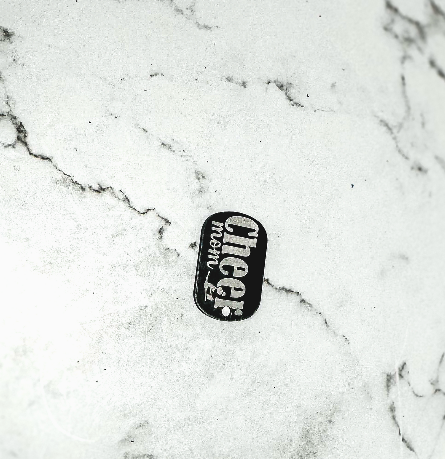 a black and white picture of a skateboard on a marble surface