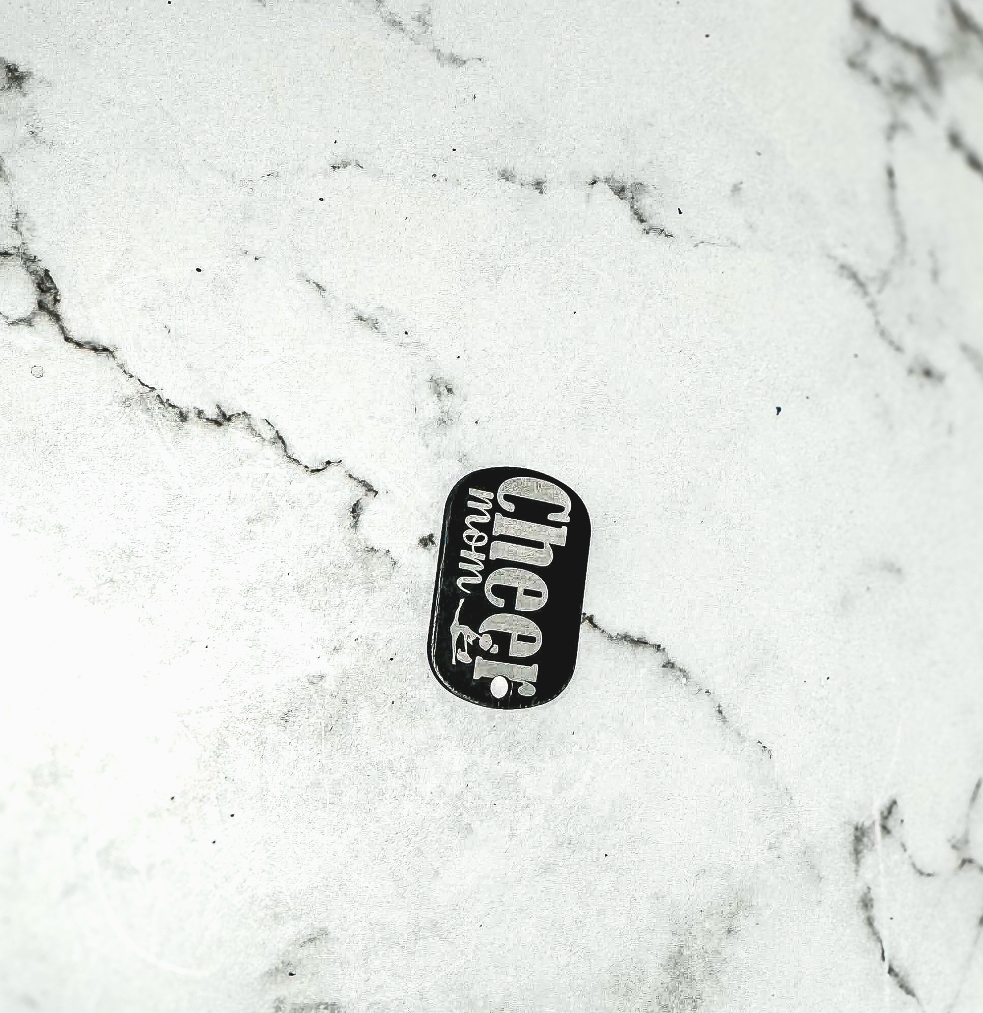 a black and white picture of a skateboard on a marble surface
